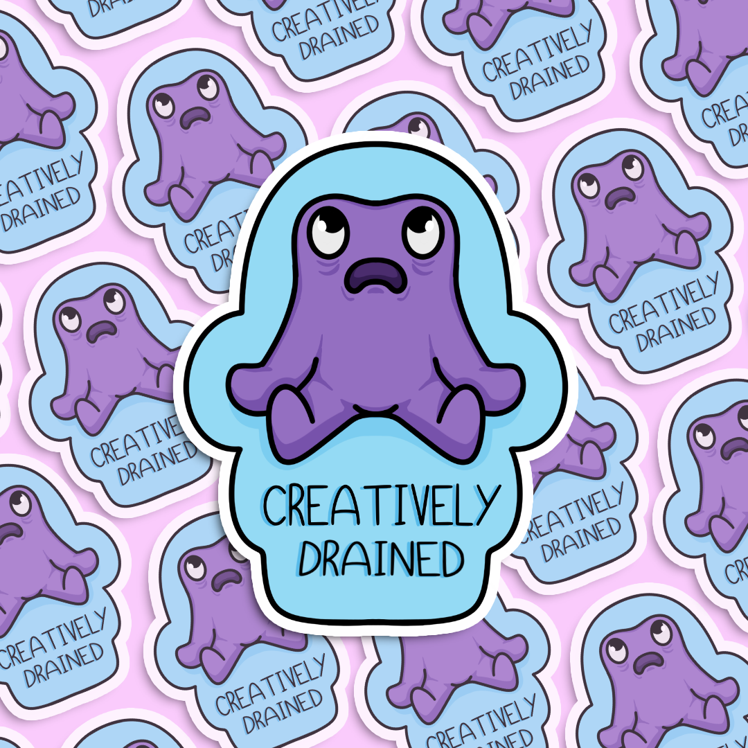Sticker with a tired purple cartoon character and 'Creatively Drained' text on a blue background.