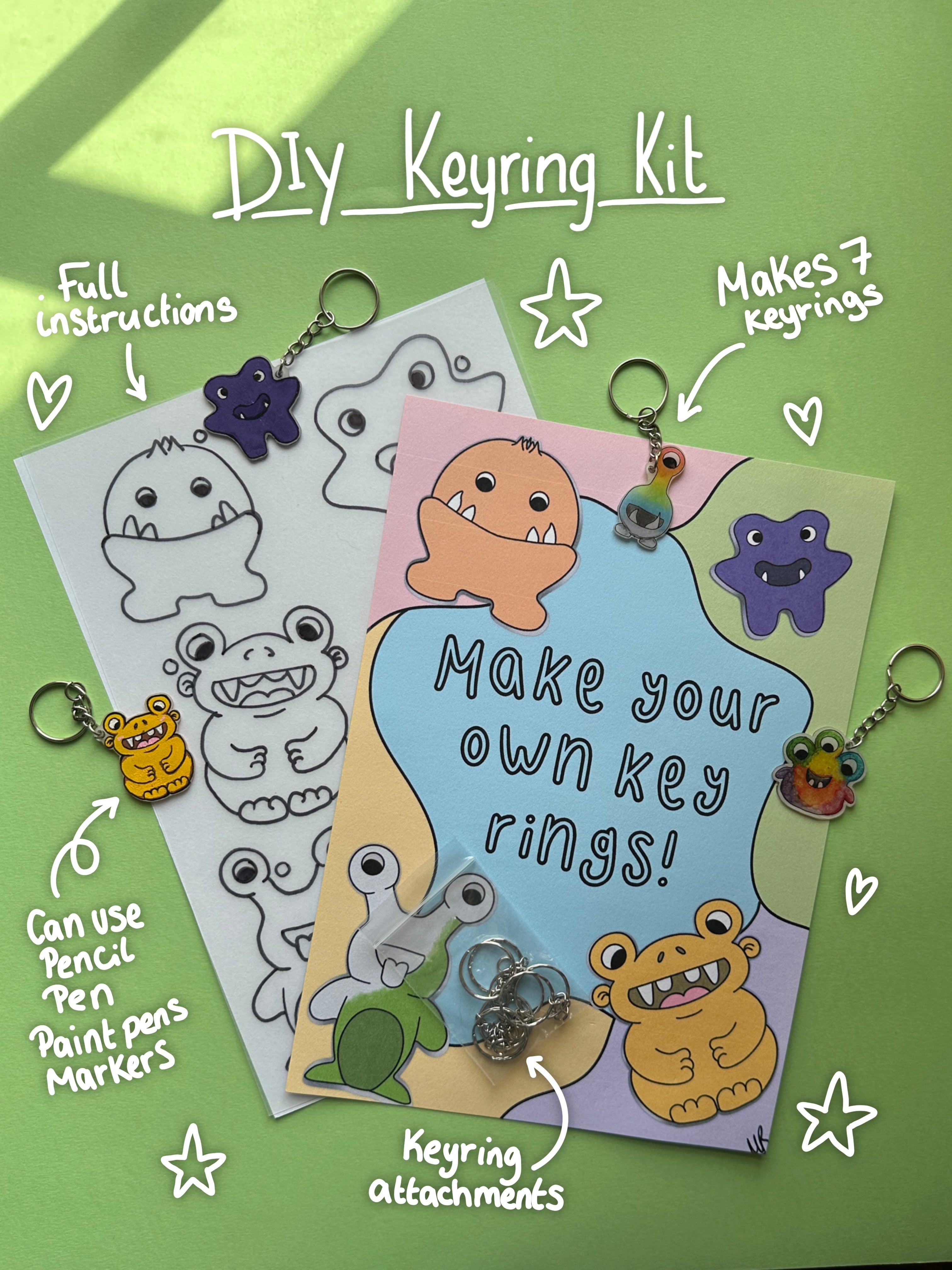 DIY keyring kit image shows frosted shrink plastic sheet with monster images printed on, ready to colour in. With instructions sheet and the keyring attachments that come in the kit. Display keyrings surround the items with white hand written notes and doodles detailing the artist materials that can be used including pencil, pen, paint pens and alcohol markers. 