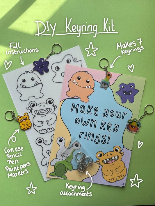DIY keyring kit image shows frosted shrink plastic sheet with monster images printed on, ready to colour in. With instructions sheet and the keyring attachments that come in the kit. Display keyrings surround the items with white hand written notes and doodles detailing the artist materials that can be used including pencil, pen, paint pens and alcohol markers. 