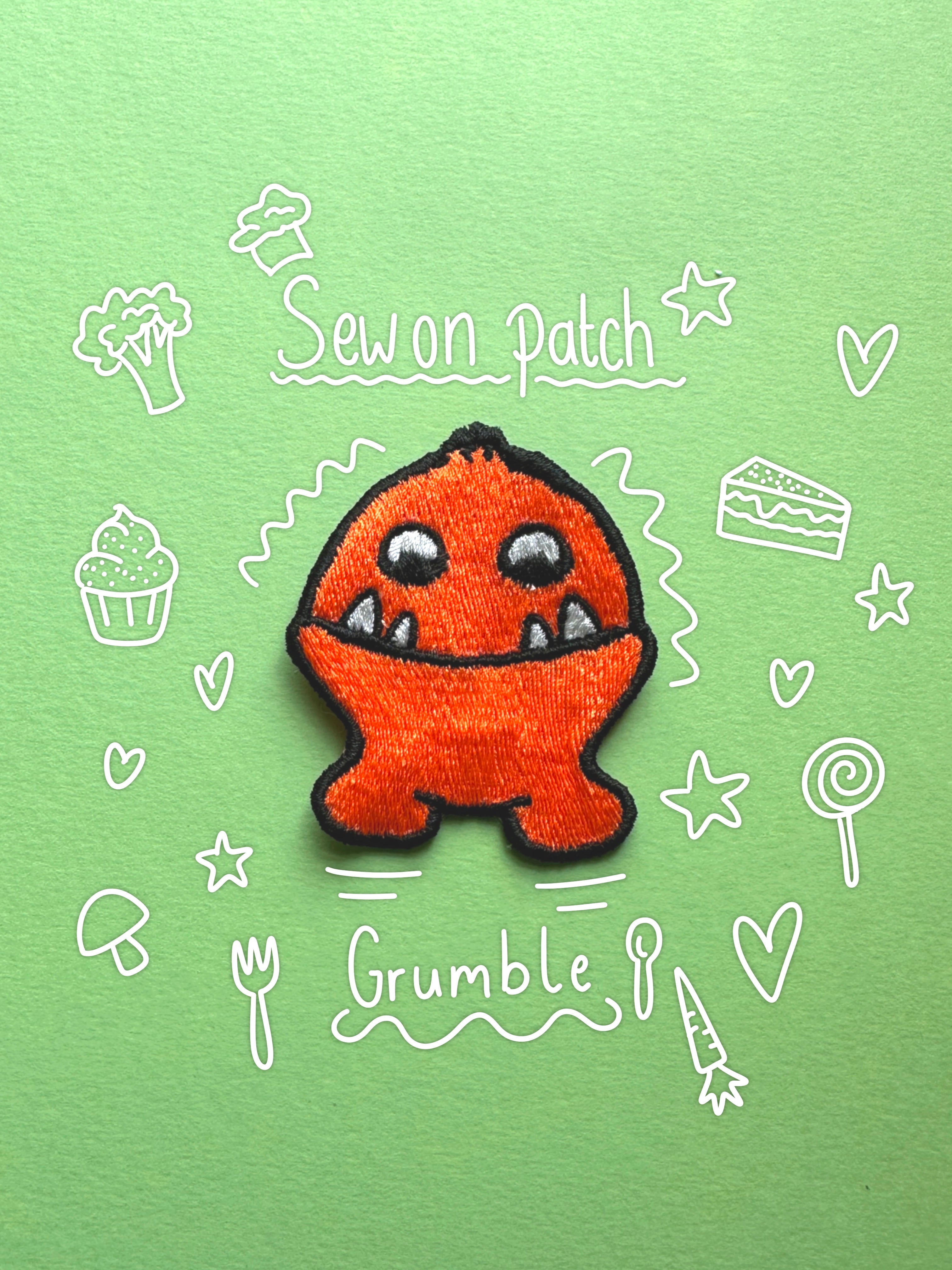 An embroidered orange monster patch with black outlines and white facial details, centered on a light green background with white hand-drawn doodles and the words 'Sew on Patch' and 'Grumble'.