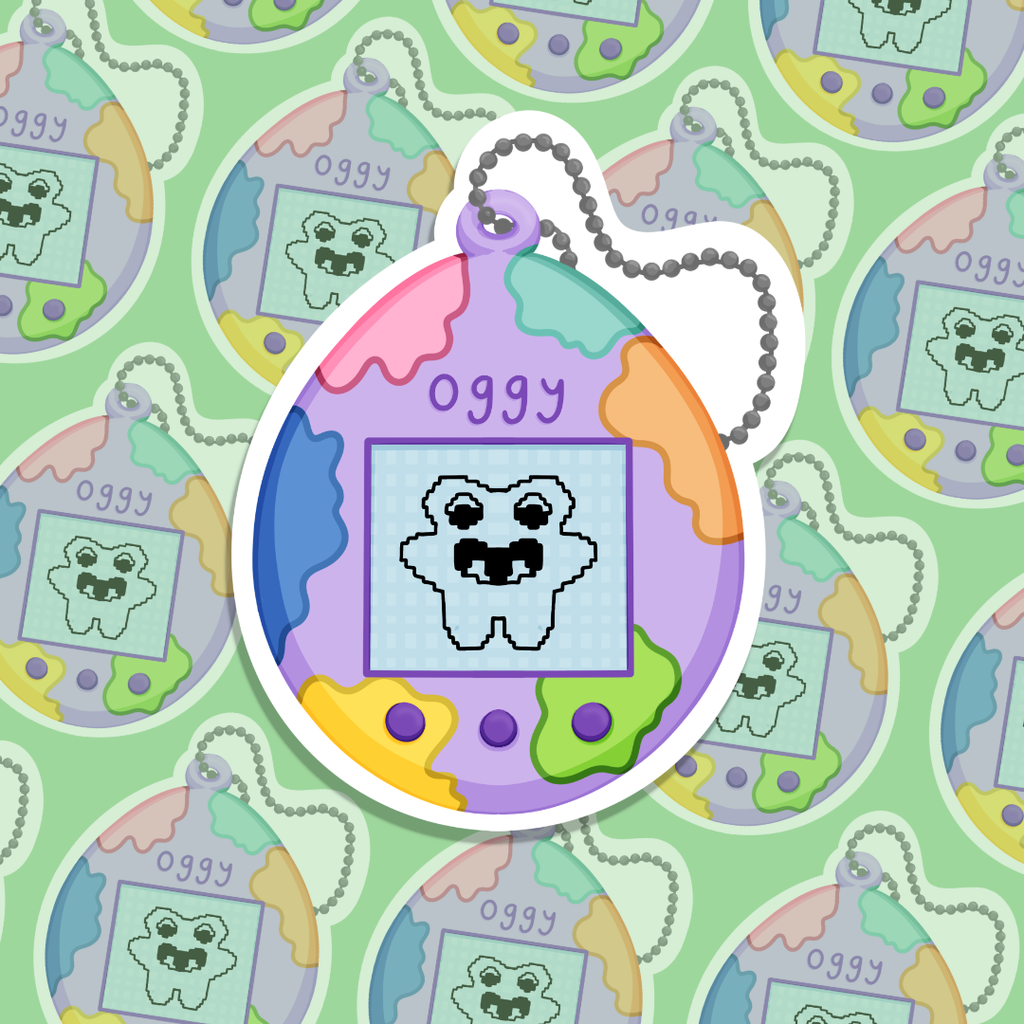 Colourful keychain tamagotchi with cartoon character sticker. 